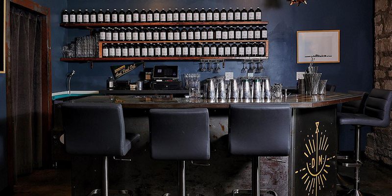 Interior of Drastic Measures with blue walls and bar seating