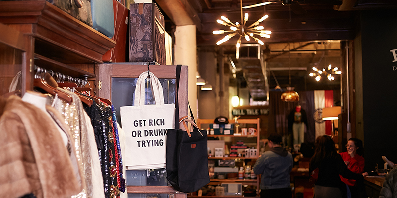 Tote bag reading "Get Rich or Drunk Trying"