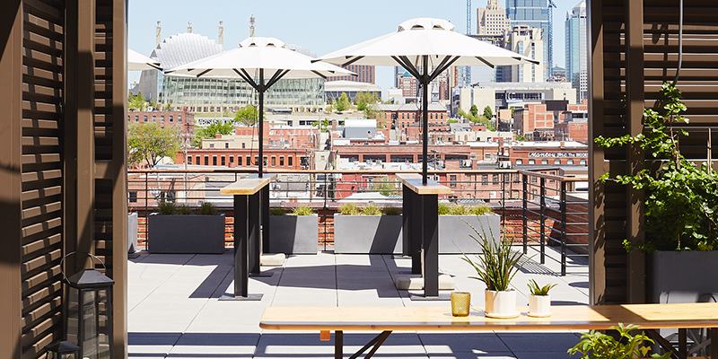 Skyline view of Kansas City with picnic tables and umbrellas in foreground