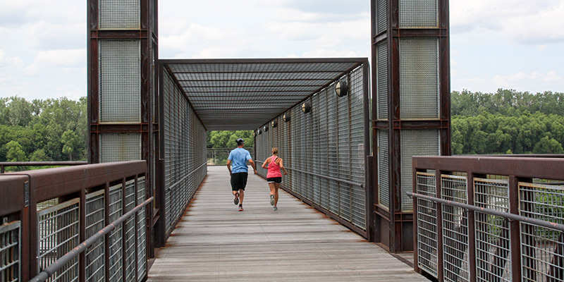 Two runners on the Town of Kansas Bridge