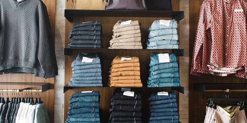Shelves at ULAH filled with jeans and button-down shirts